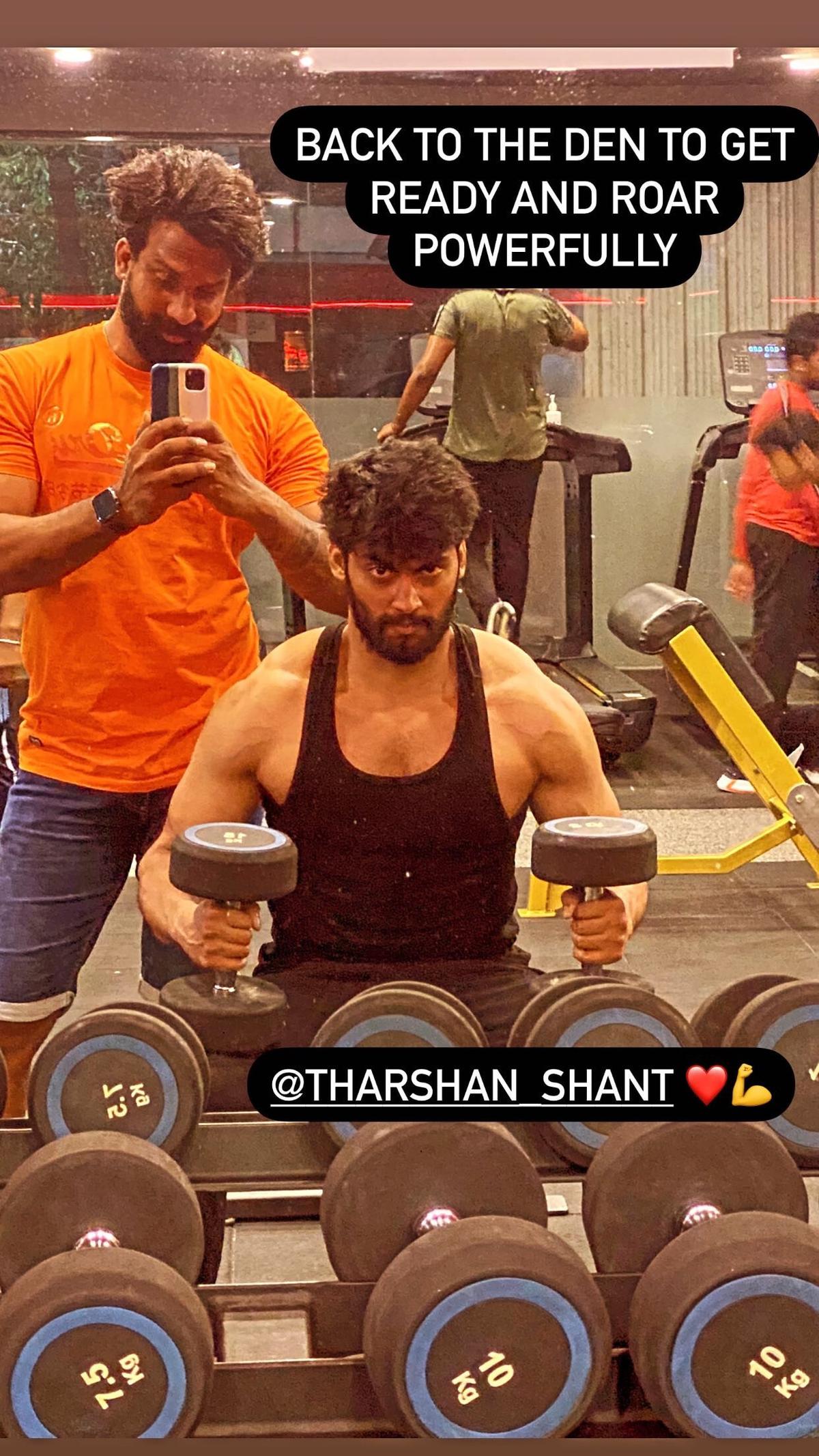 Coaching client Tharshan through a dumbbell workout
